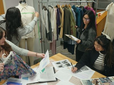 Fashion merchandising students working on project