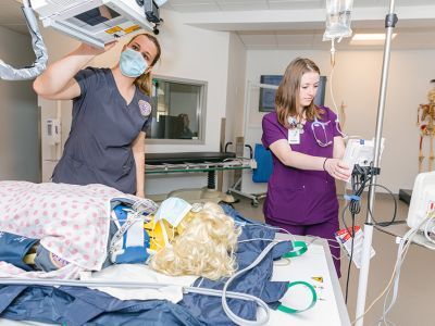 two nursing students performing simulation exercise