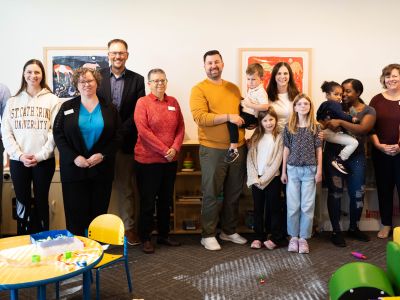 A group of people stand together in the Access and Success office. 