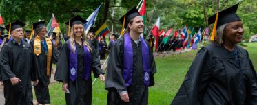 College for Adult graduates walking in graduate procession