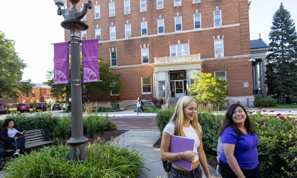 Students walk in front of Derham on the St. Catherine University campus