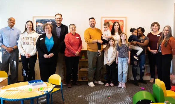 A group of people stand together in the Access and Success office. 