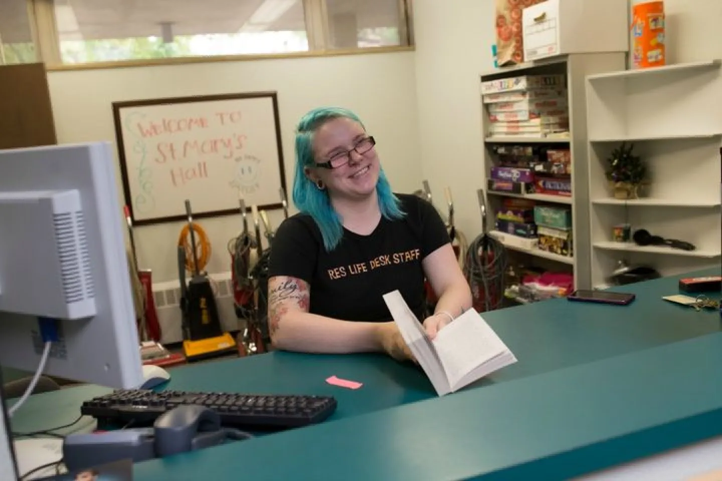 Photo of Front Desk of St. Mary Hall with Student Res Life student worker