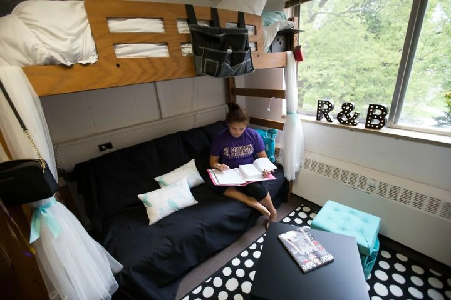 student on bunk bed in St. Mary Hall dorm room