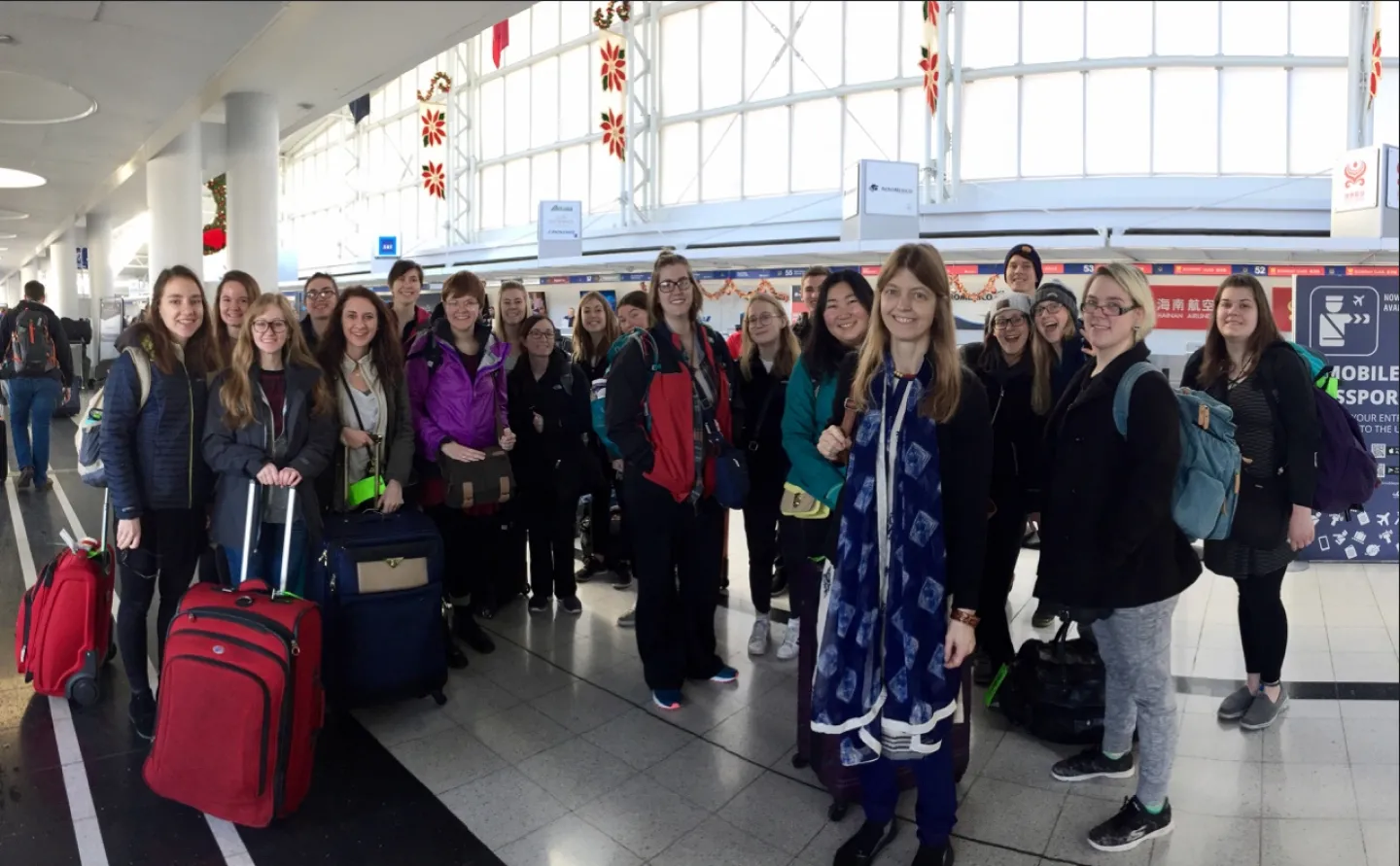 Away we go: Professor Emily West (third from right, in blue) with Nepal-bound students. Photo by Jeff Johnson.