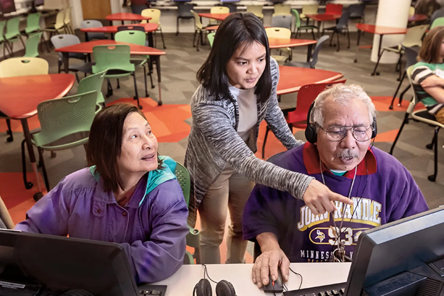 Nayni paung '20 (center), a public health major, assists two patrons of the rondo community library during an open lab session. Paung is employed at the library in the community leader program through st. kate's center for community work and learning, one of the many service-learning opportunities offered to students.