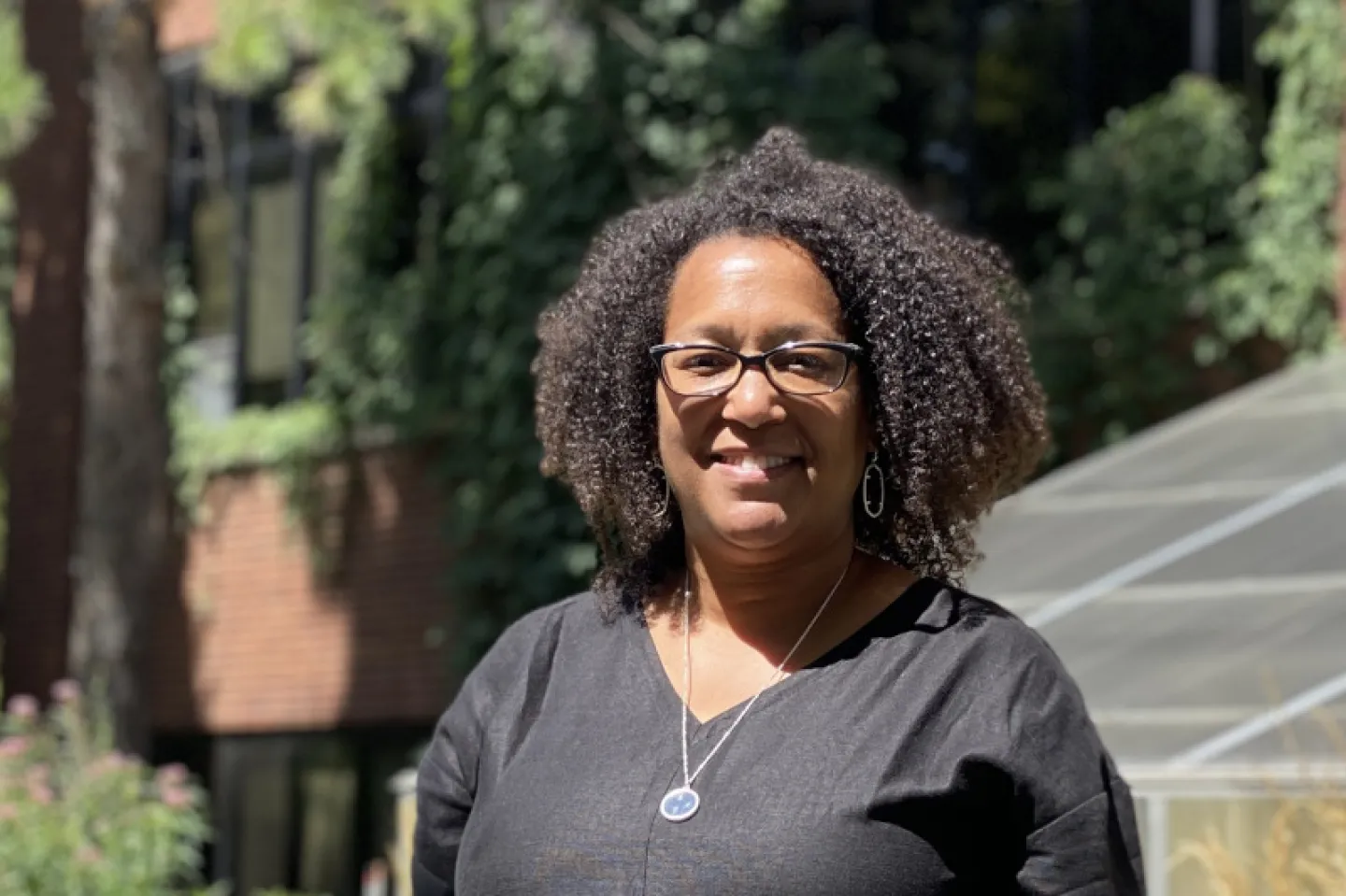 Taviare Hawkins stands in front of Mendel and the Visual Arts Building