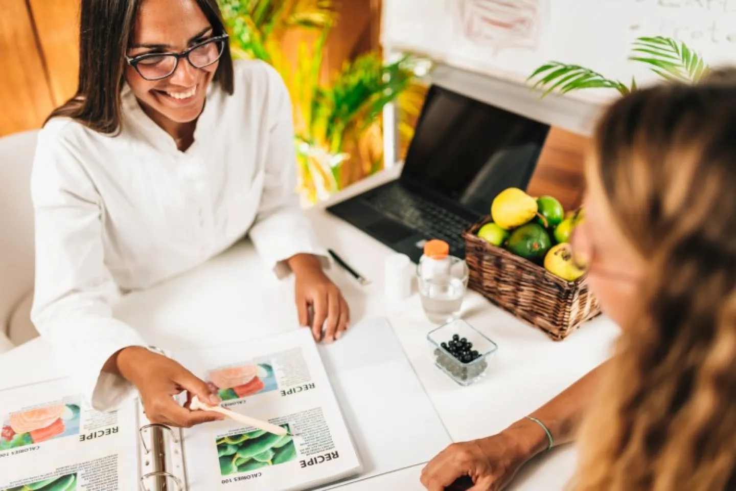 A nutritionist consults with a client. 