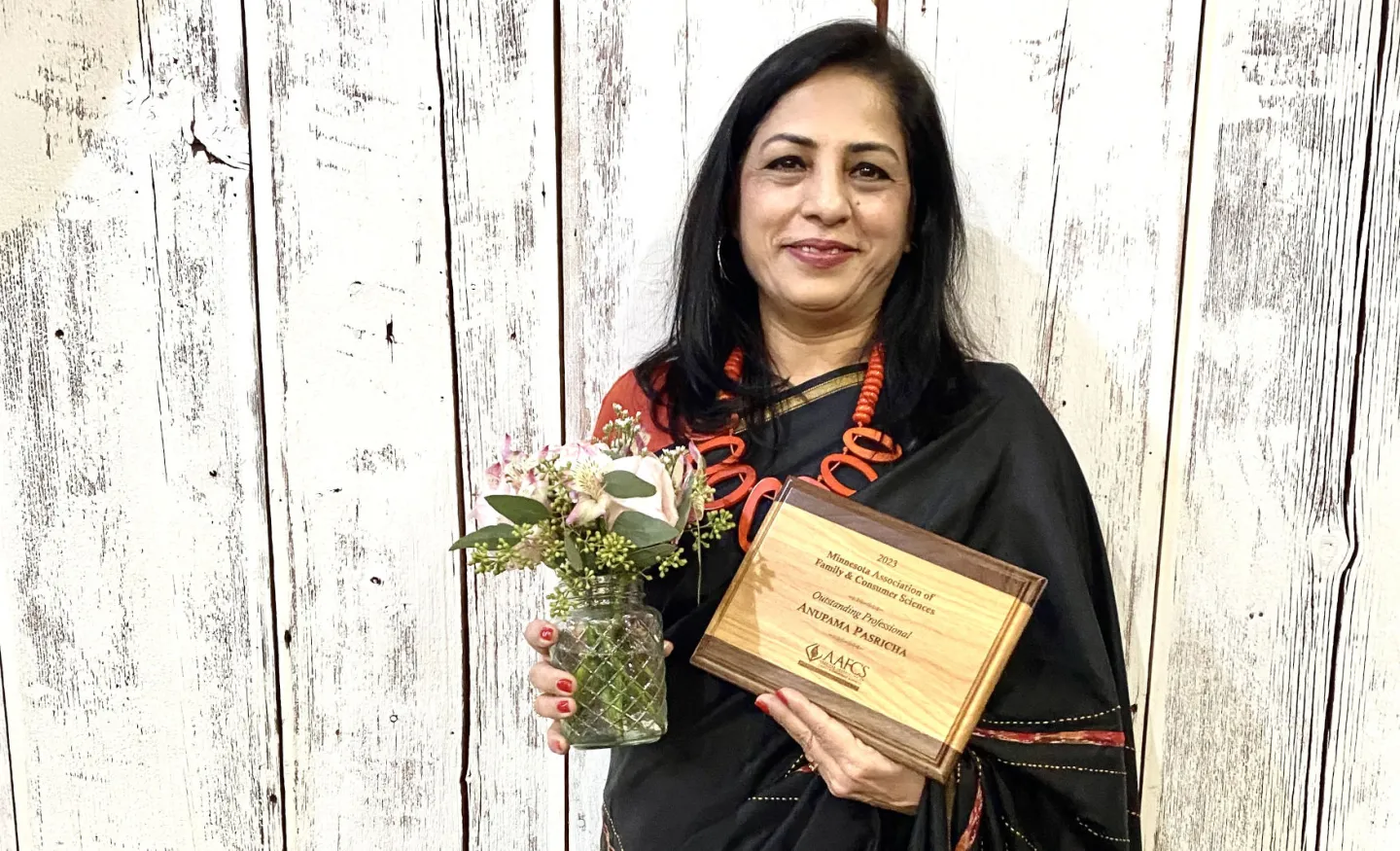 Anupama Pasricha, PhD, with MAFCS award and flowers