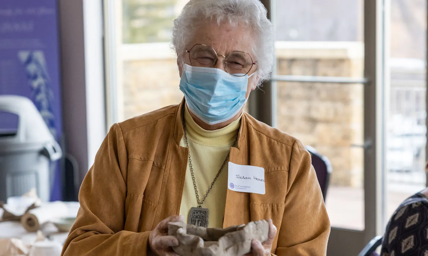 A Sister of St. Joseph of Carondelet holds a pottery bowl