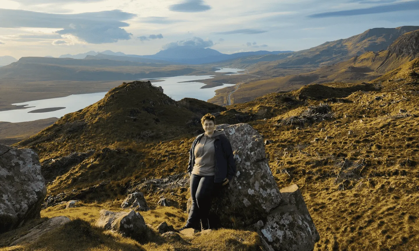 A student stands amid the Scottish Highlands