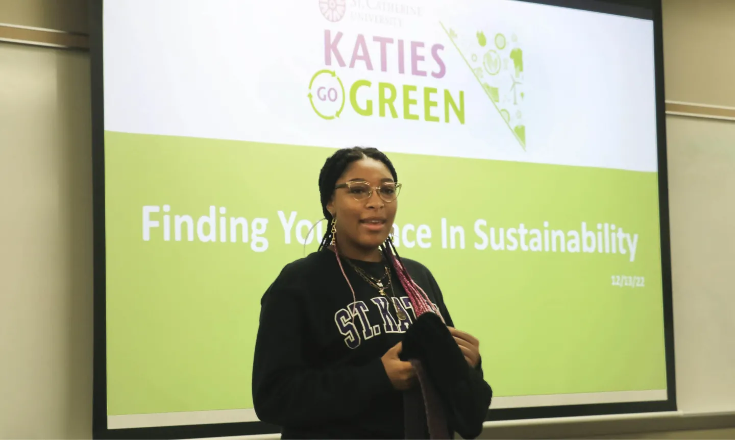 Mikayla Roper ’26 presents in front of a screen that says, "Finding Your Place in Sustainability"