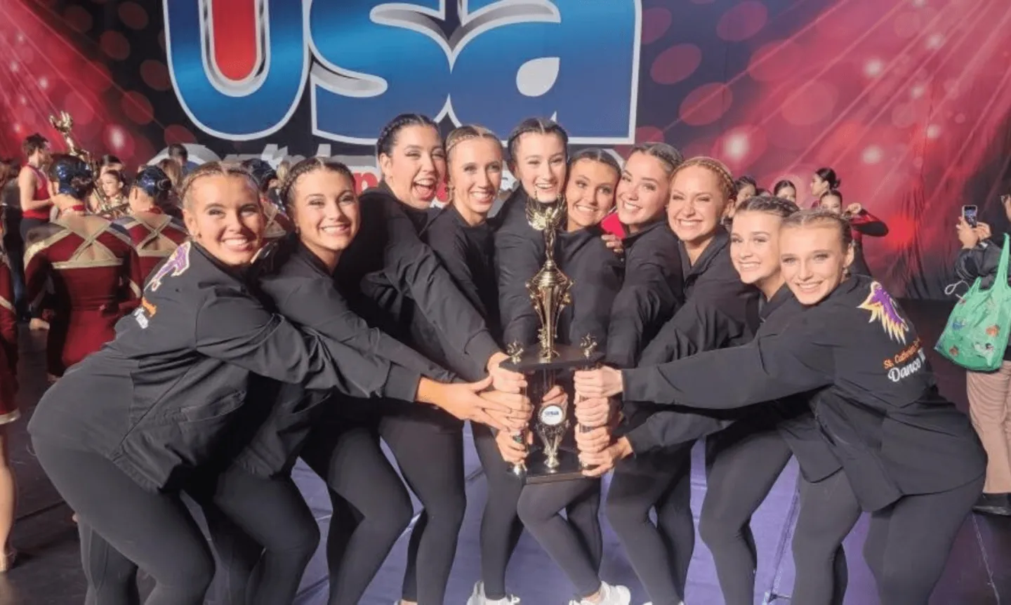 Wildcat dance team poses with a trophy
