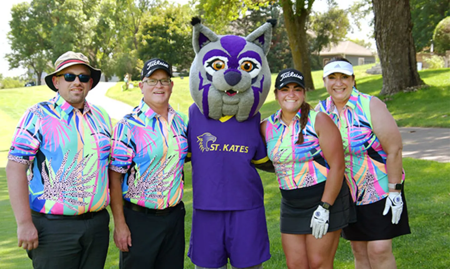 Katie Kat with golfers at the annual fundraising golf tournament.