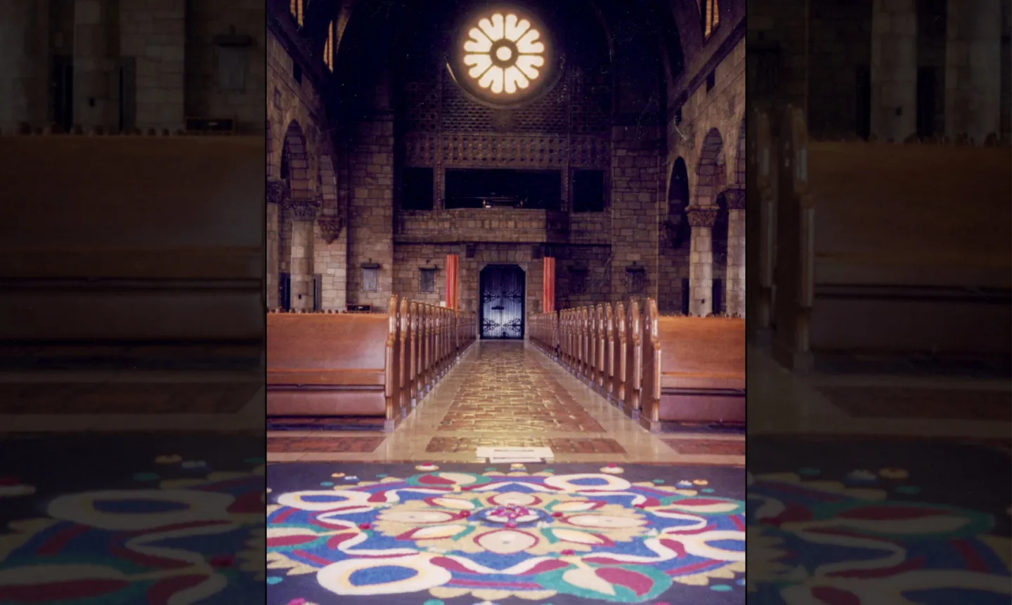 Interior photo of the Chapel with a mandala on the ground.