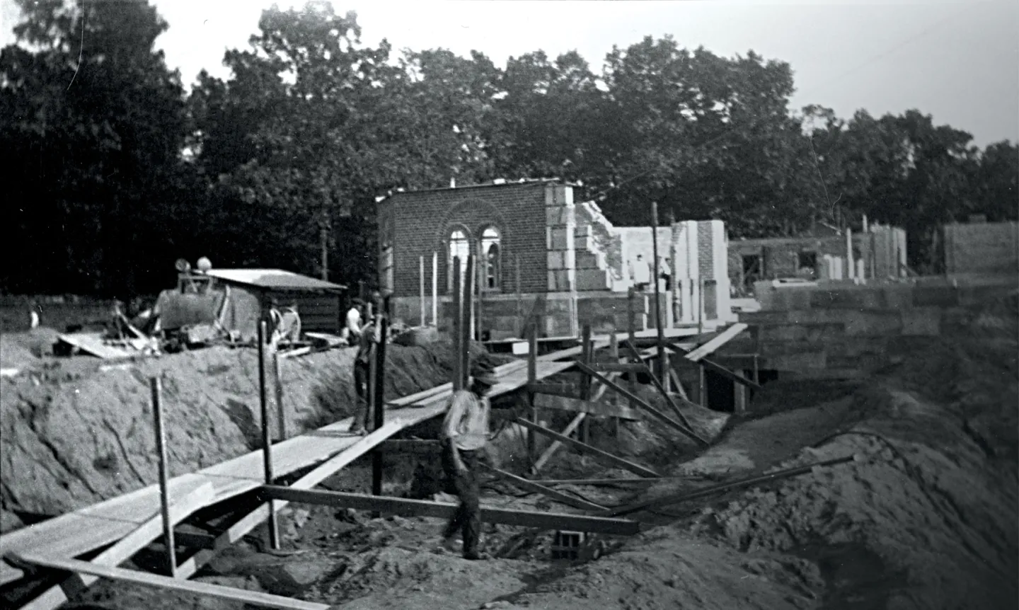 A black-and-white photo of Our Lady of Victory Chapel construction.