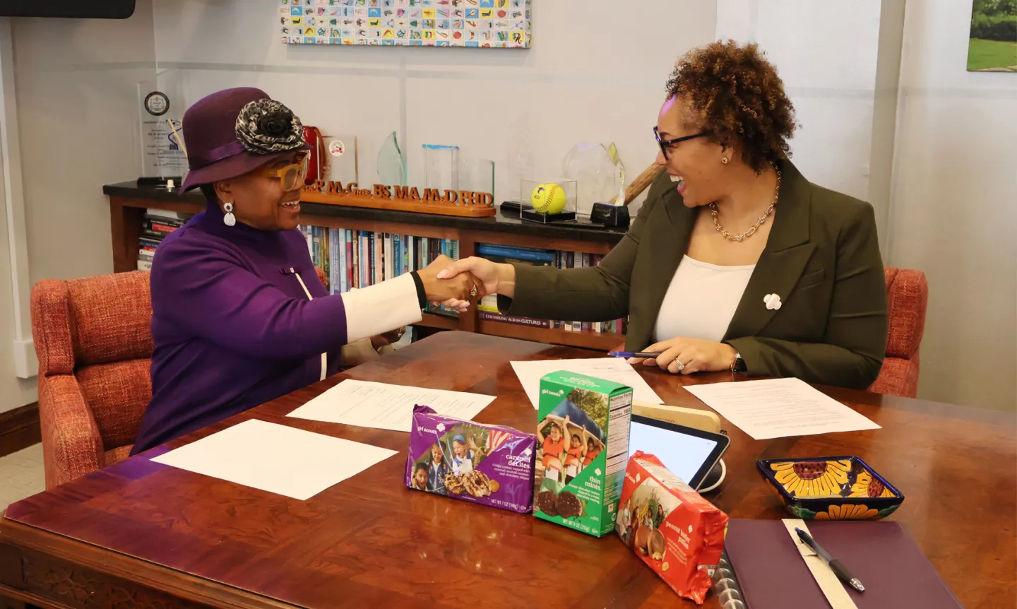 President Marcheta P. Evans, PhD, (left) and Marisa C. Williams (right) shake hands