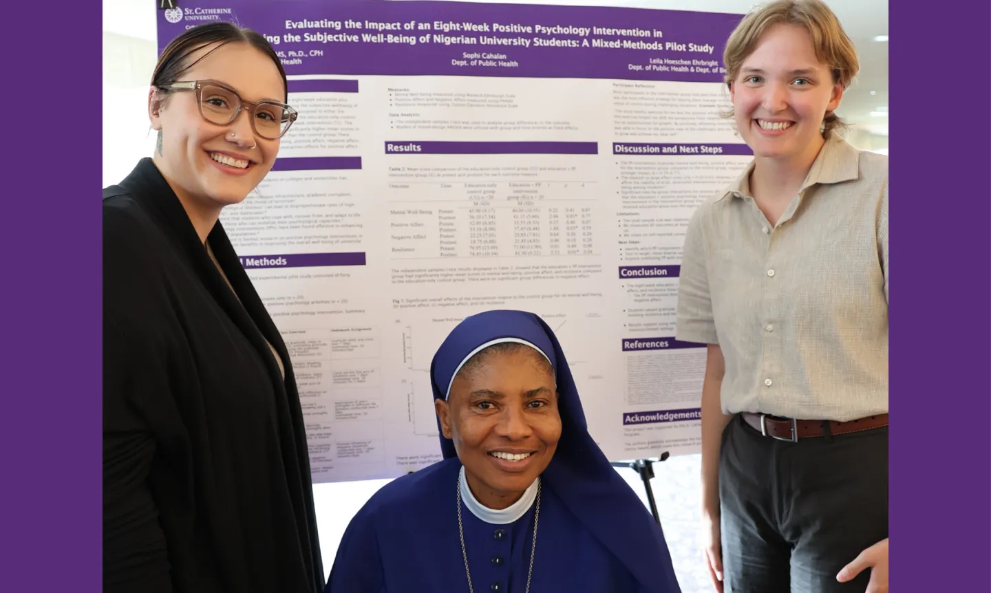Two students and their faculty mentor stand in front of their research poster.