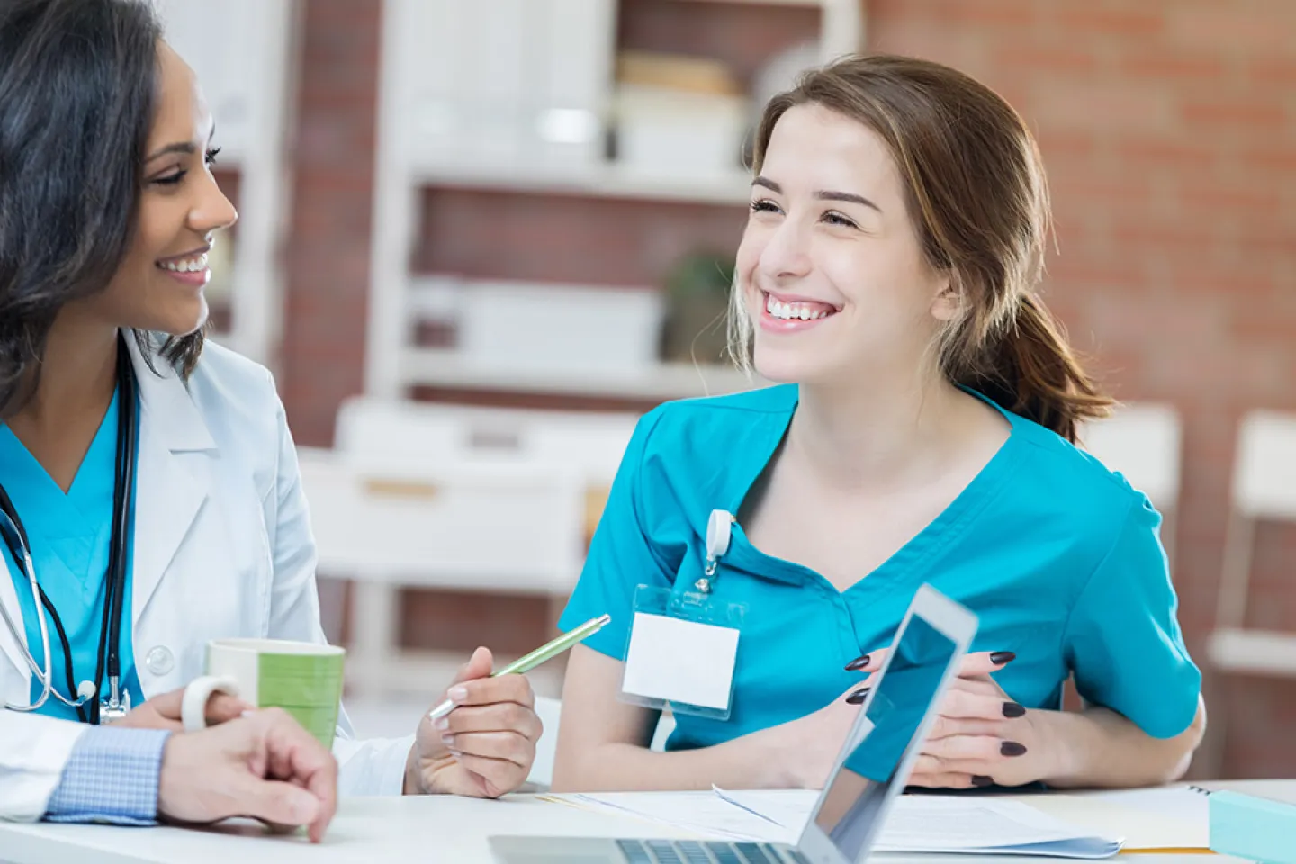 Two RN's talking at nurses station