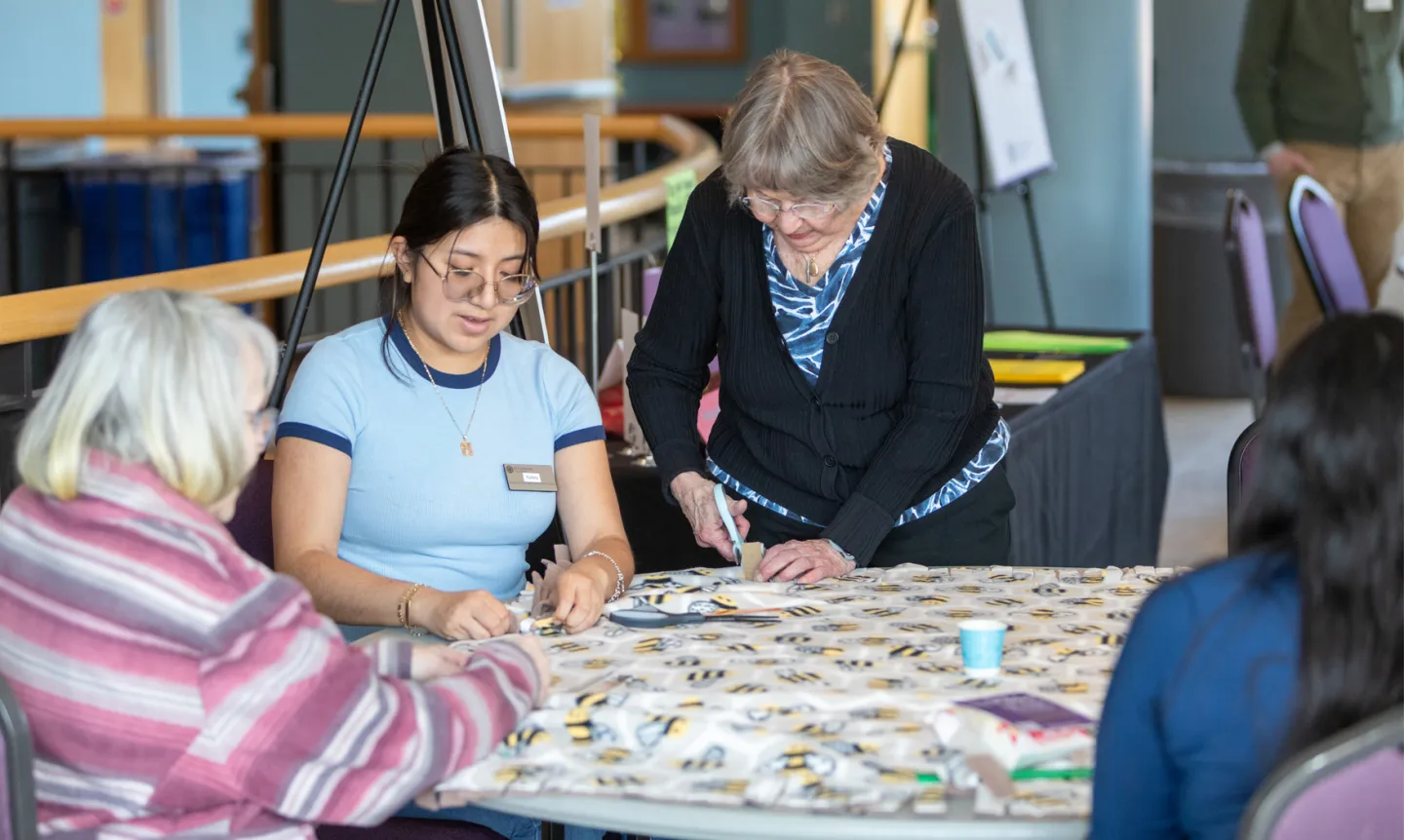 Volunteers cut fabric at the Feast of Saint Joseph 2025