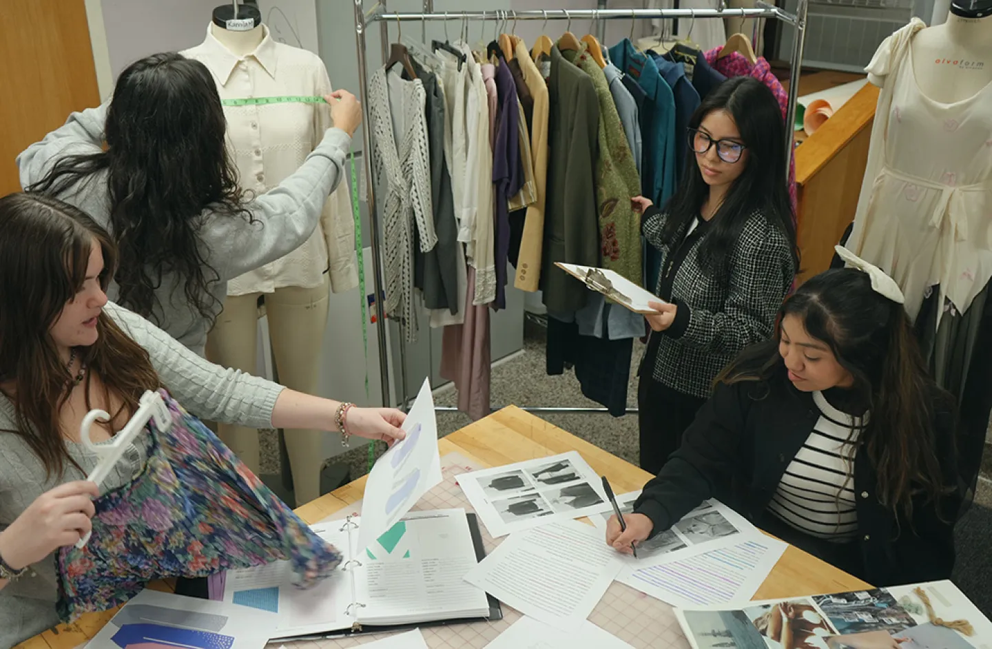 Fashion merchandising students working on project