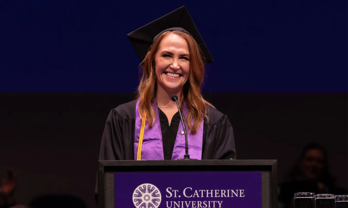 Amanda Sperling ’25, College for Adults Commencement speaker at the podium