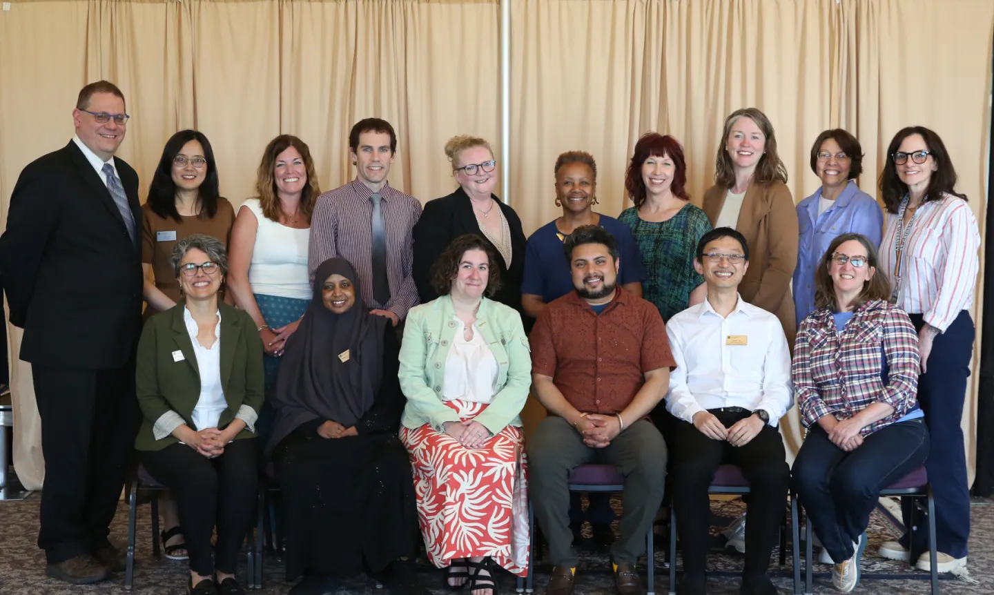2026's promoted and tenured faculty and staff pose for a group portrait