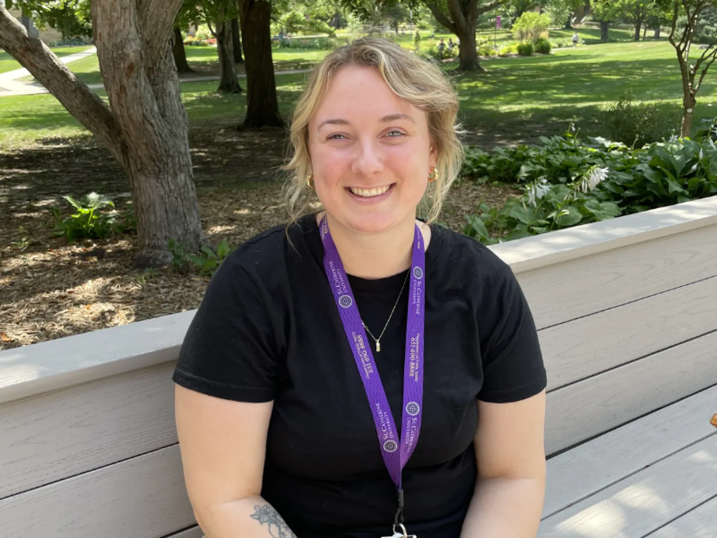 white woman with blonde hair and black shirt smiling