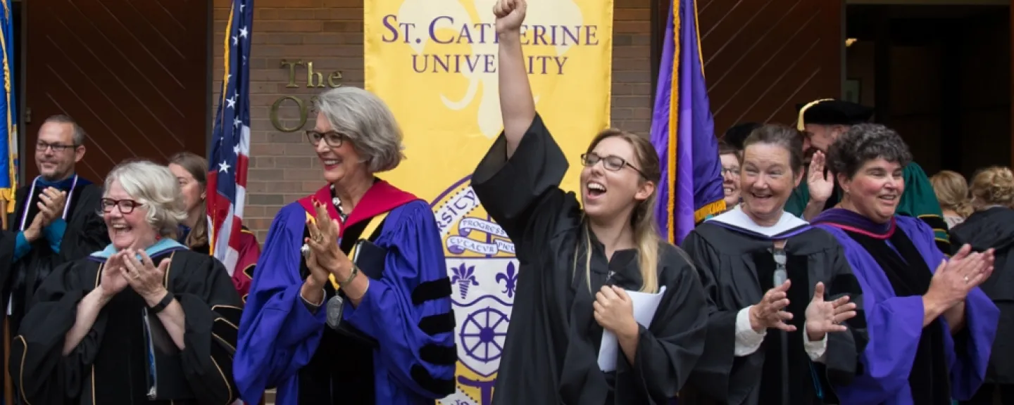 Photo title is "convo" - a convocation/graduation ceremony, outside in sunshine (so probably May), and featuring University President ReBecca Roloff '76 (so probably in 2017, 2018, or 2019).