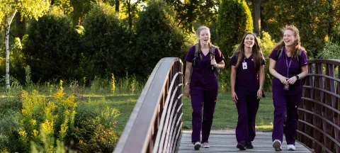 Three nursing students walking together on campus